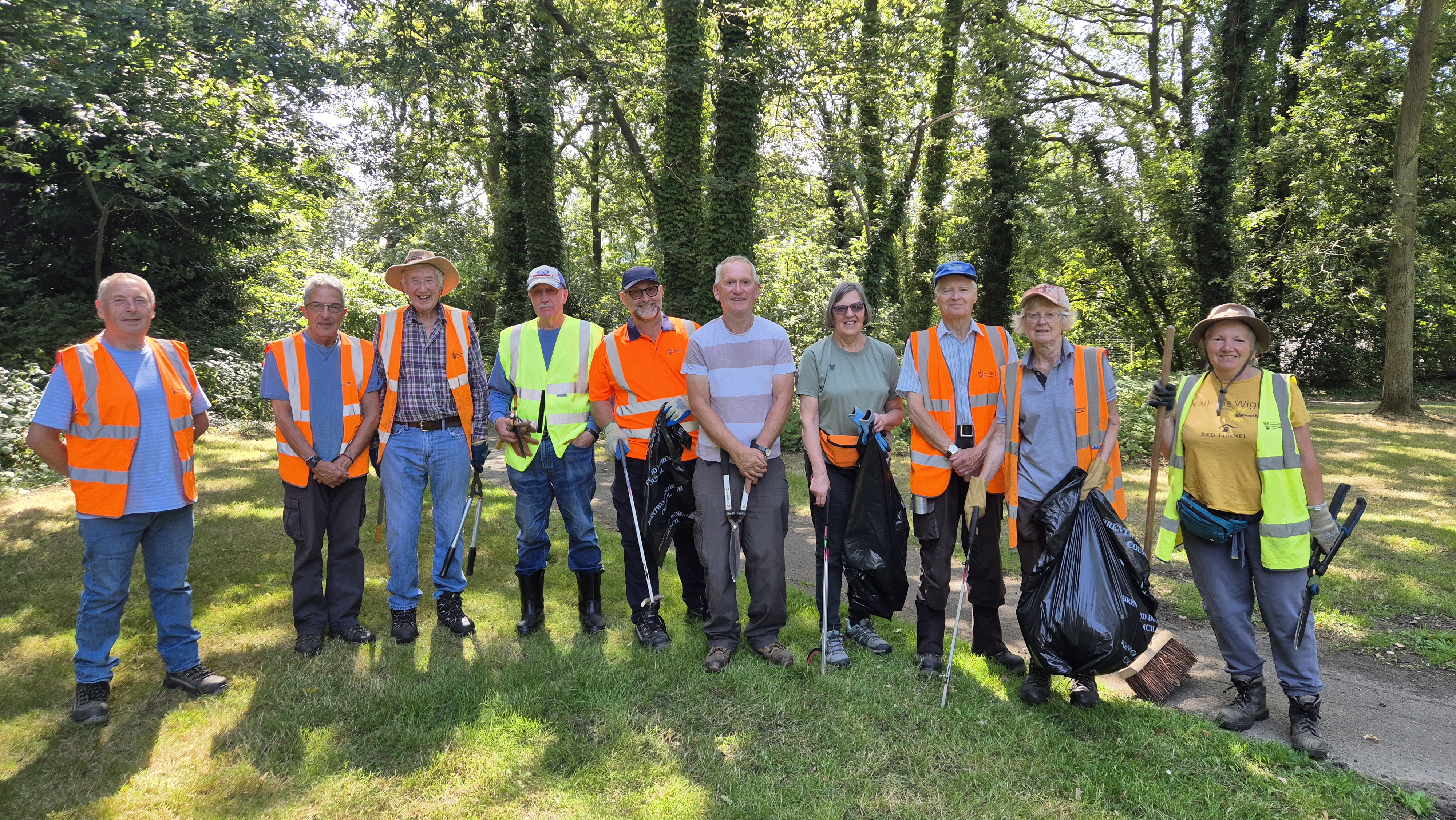 volunteers with hi vis vests in a forest