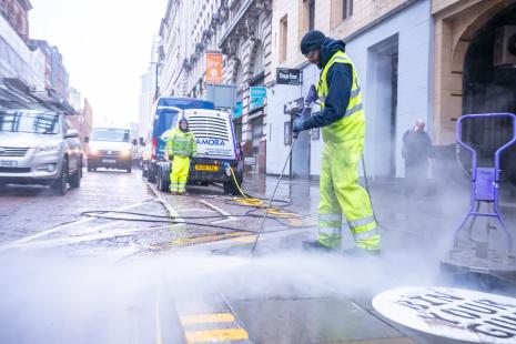 Chewing gum being cleaned off a street by the Chewing Gum Task Force
